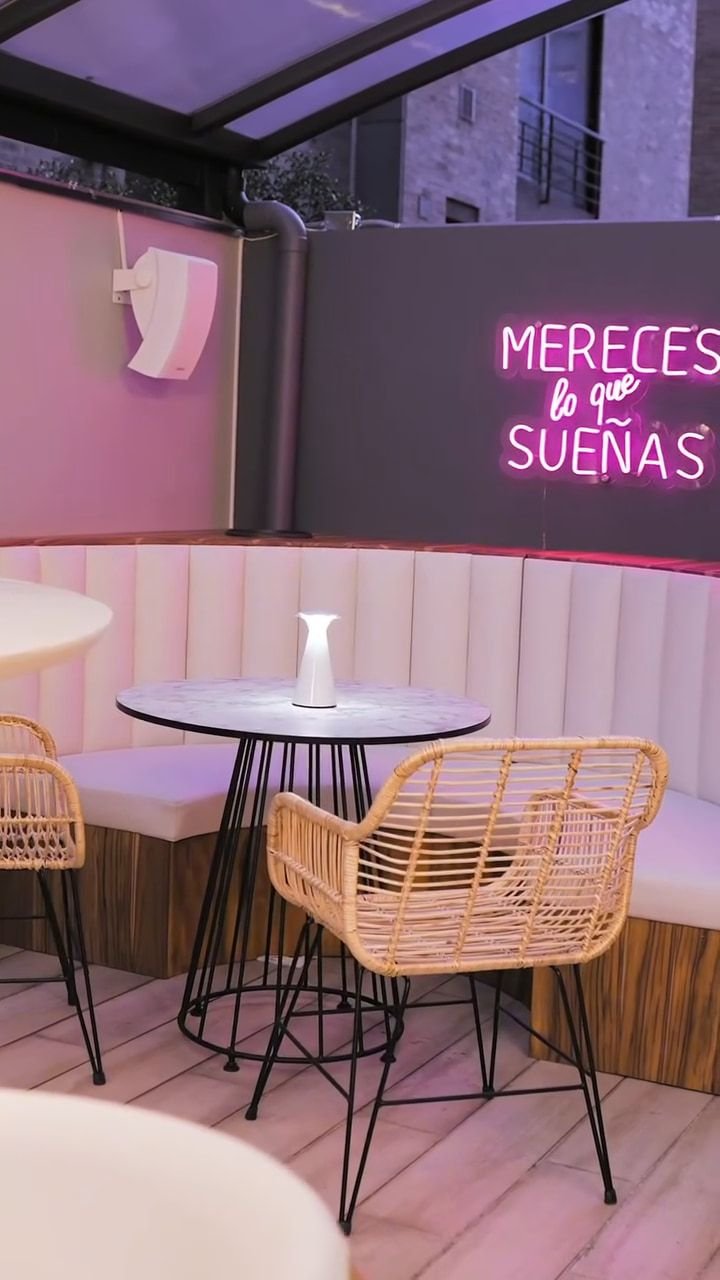 Terraza con sillas de ratán y mesas de mármol